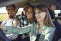 A group of happy friends are driving in a car. Royalty Free Stock Photo