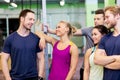 Group of happy friends in gym Royalty Free Stock Photo