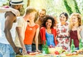 Group of happy friends having fun at barbecue party outdoor in house backyard - Young diverse culture people making bbq dinner - Royalty Free Stock Photo