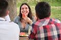 Group of happy friends having fun, drinking and eating watermelon in a park Royalty Free Stock Photo