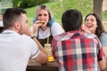 Group of happy friends having fun, drinking and eating watermelon in a park Royalty Free Stock Photo