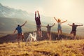 Group of friends runs and jumps in mountains Royalty Free Stock Photo