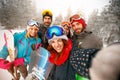 Group of happy friends having fun Snowboarders and skiers making Royalty Free Stock Photo