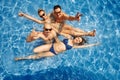 Happy friends having fun in swimming pool Royalty Free Stock Photo