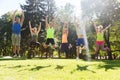 Group of happy friends jumping high outdoors