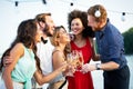 Group of happy friends partying and toasting drinks Royalty Free Stock Photo