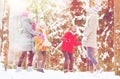 Group of happy friends playing snowballs in forest