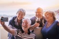 Group of happy friends senior people have fun together with social contact doing selfie with a smart phone - mature celebrate in