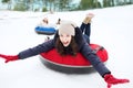 Group of happy friends sliding down on snow tubes Royalty Free Stock Photo