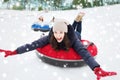 Group of happy friends sliding down on snow tubes Royalty Free Stock Photo