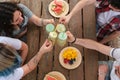 Group of happy friends toasting, having fun, drinking and eating fruit in a park Royalty Free Stock Photo