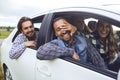 A group of happy friends are driving in a car. Royalty Free Stock Photo