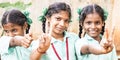 Group of happy funny children friends classmates smiling doing victory peace sign gesture with fingers at the school. School kids Royalty Free Stock Photo