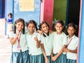 Group of happy funny children friends classmates smiling doing victory peace sign gesture with fingers at the school. School kids Royalty Free Stock Photo