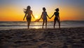 Group of happy girls running and playing on sand at sunset Royalty Free Stock Photo