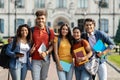 Group of happy international students posing outdoors near university building Royalty Free Stock Photo