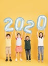 Group of happy kids celebrating and showing 2020 new year concepts