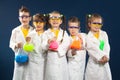 Group happy kids doing science experiments in the laboratory. Royalty Free Stock Photo