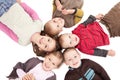 Group of happy kids lying on backs on floor Royalty Free Stock Photo