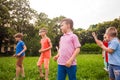 Group of happy kids playing games on green field outdoors Royalty Free Stock Photo