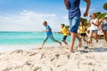 Group of happy kids running on white sand beach Royalty Free Stock Photo