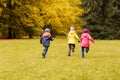 Group of happy little kids running outdoors Royalty Free Stock Photo