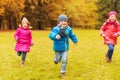 Group of happy little kids running outdoors Royalty Free Stock Photo