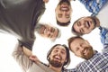 Group of happy male friends huddling, looking down at camera, smiling, and laughing Royalty Free Stock Photo