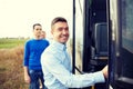 Group of happy male passengers boarding travel bus Royalty Free Stock Photo