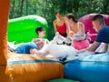 Group of happy men and women swimming in foam pool in adventure park Royalty Free Stock Photo