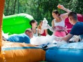 Group of happy men and women swimming in foam pool in adventure park Royalty Free Stock Photo