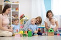 Group of happy moms with their babies in nursery Royalty Free Stock Photo