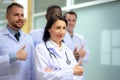 Group Of Happy multicultural doctors showing thumbs up and smiling. Portrait of multiracial medical specialists in white lab coats Royalty Free Stock Photo