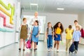 group of happy multiethnic classmates walking