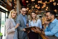 Group of happy multiethnic successful business people having fun, work and meeting in cafe. Royalty Free Stock Photo