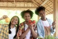 Group of happy Multiethnic teenager friend holding organic food products from their own farm at local market fair, smiling young Royalty Free Stock Photo