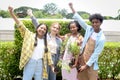 Group of happy Multiethnic teenager friend holding sapling tree, smiling young diverse farmer preparing for planting, raising Royalty Free Stock Photo