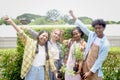 Group of happy Multiethnic teenager friend holding sapling tree, smiling young diverse farmer preparing for planting, raising