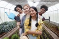 Group of happy Multiethnic teenager friend work in vegetable farm, portrait of smiling young diverse farmer standing together,