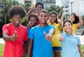 Group of happy multiethnic young adults showing thumbs Royalty Free Stock Photo