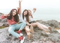 Group of happy multiracial female tourists having fun and smiling - Best friends enjoy their vacation while relaxing sitting on Royalty Free Stock Photo