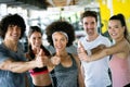 Group of happy multiracial friends exercising together in gym Royalty Free Stock Photo