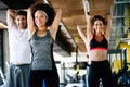 Group of happy multiracial friends exercising together in gym Royalty Free Stock Photo
