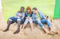 Group of happy multiracial friends having fun together using mobile phone Royalty Free Stock Photo