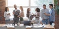 Multiracial young happy people sharing ideas while coffe break