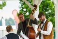 Group of Happy Musicians Playing at an Outdoor Event. Royalty Free Stock Photo