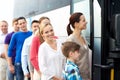 Group of happy passengers boarding travel bus Royalty Free Stock Photo