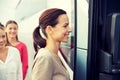 Group of happy passengers boarding travel bus Royalty Free Stock Photo