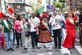 Group of happy people in bright costumes marching during the Mexican Independence Day Parade