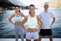 Group of happy people exercising outdoor. Sport, fitness, friendship and healthy lifestyle concept